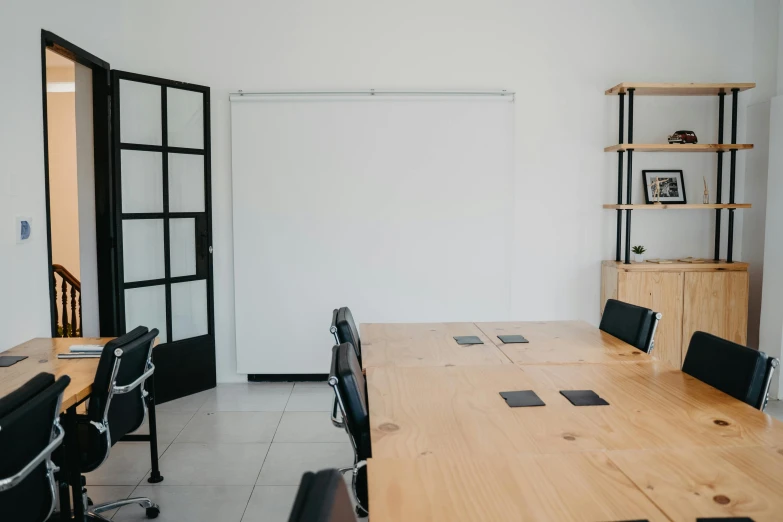 a conference room with a wooden table and black chairs, unsplash, light and space, whiteboard, background image, full body image