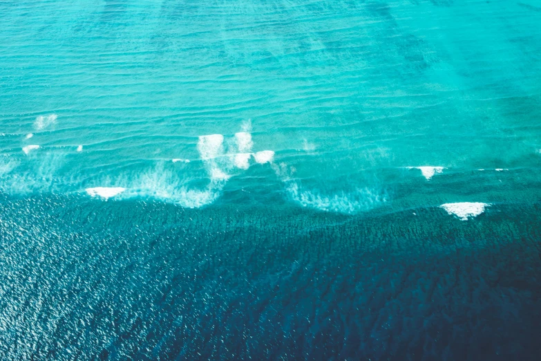 an aerial view of a body of water, pexels contest winner, ocean spray, half blue, manly, retrowaves