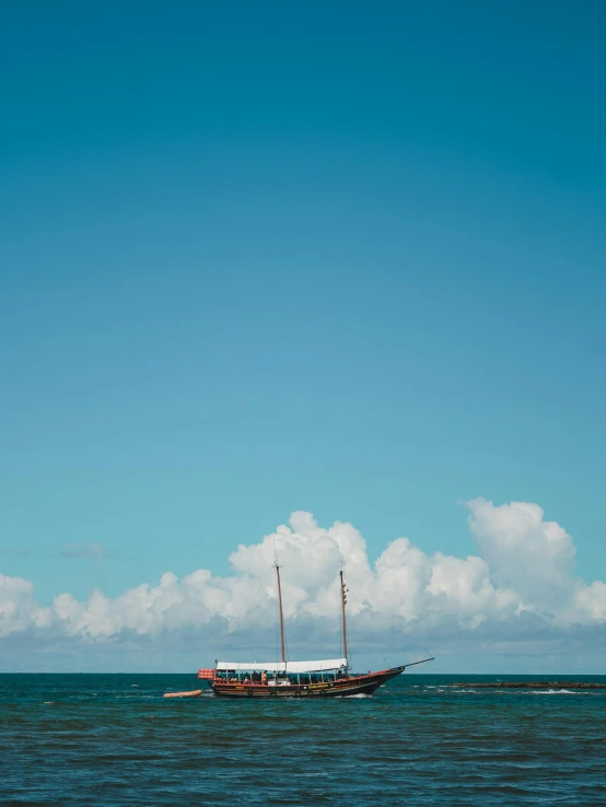 a boat floating on top of a body of water, view of the ocean