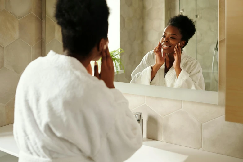 a woman that is standing in front of a mirror, pexels contest winner, happening, skincare, brown skinned, morning time, pleasing