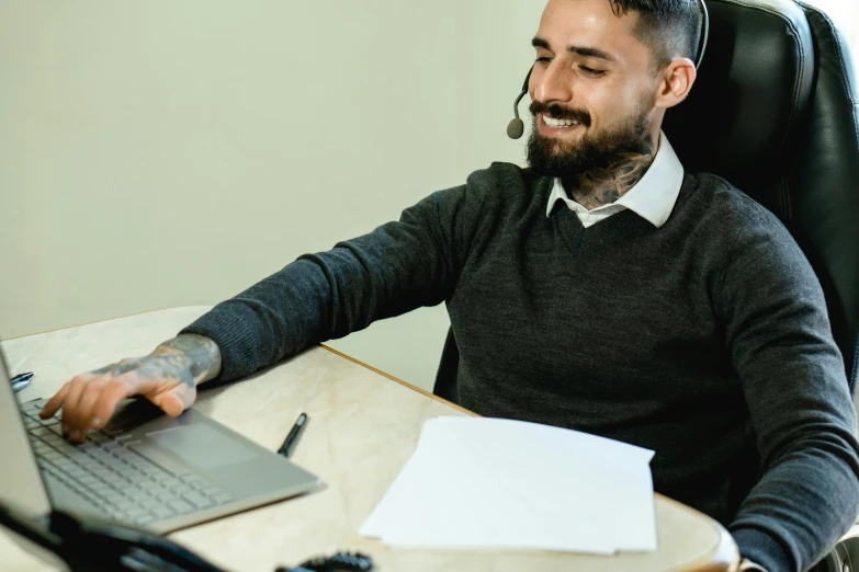 a man sitting at a desk using a laptop computer, pexels contest winner, hurufiyya, working in a call center, lachlan bailey, holding a staff, thumbnail