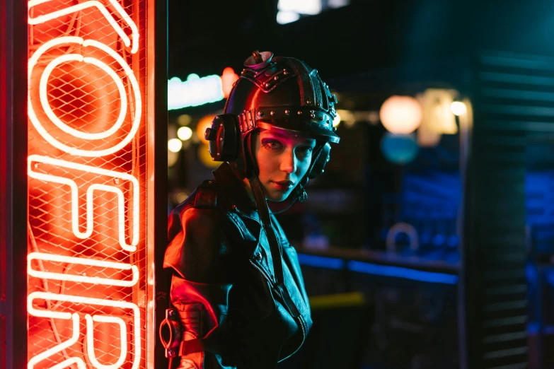 a woman standing in front of a neon sign, cyberpunk art, unsplash contest winner, leds visor helmet, a black dieselpunk policewoman, cinematic outfit photo