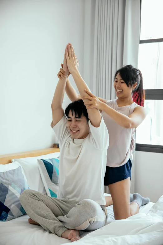 a man and a woman doing yoga on a bed, inspired by Gong Kai, pexels contest winner, greeting hand on head, teenage boy, asian male, wearing a shirt