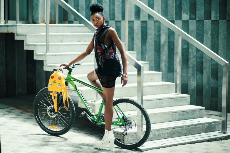 a woman standing next to a green bike, pexels contest winner, afrofuturism, off - white collection, wearing a tank top and shorts, with a backpack, lady using yellow dress