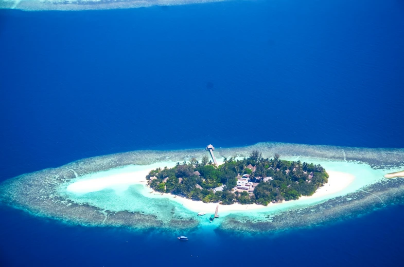 a small island in the middle of the ocean, pexels contest winner, hurufiyya, resort, 1970s photo, monkey island, thumbnail