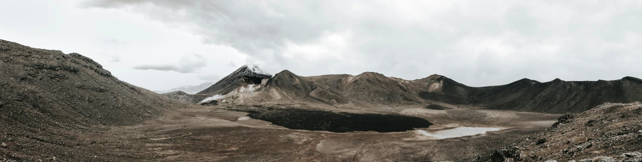 a group of people standing on top of a mountain, a matte painting, trending on unsplash, hurufiyya, black volcano afar, background image, minimalist photo