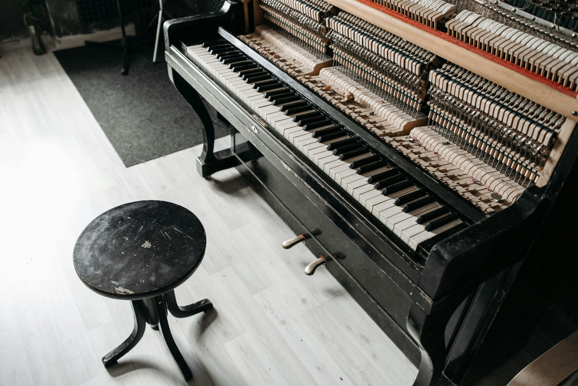 a piano sitting on top of a hard wood floor, by Niko Henrichon, pexels contest winner, modernism, studio bones, mixed materials, 15081959 21121991 01012000 4k, black lacquer