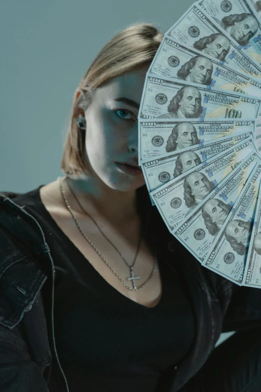 a woman holding a fan in front of her face, an album cover, inspired by Elsa Bleda, trending on unsplash, hyperrealism, dollar bills body horror, imogen poots as holy paladin, 2 0 2 1 cinematic 4 k framegrab, bank robbery movies