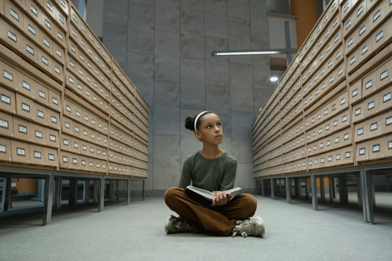 a woman sitting on the floor reading a book, pexels contest winner, hyperrealism, inside a science facility, still from alita, looking upwards, girl looks at the space