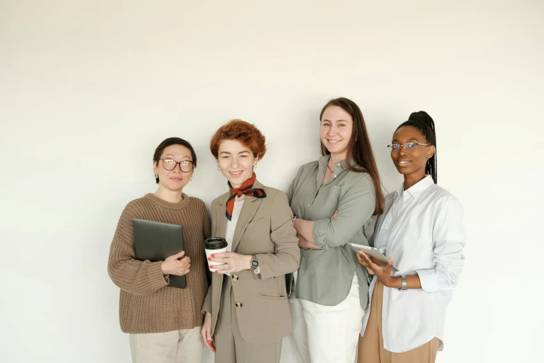 a group of women standing next to each other, a picture, trending on pexels, female in office dress, pale - skinned, ( ( brown skin ) ), student