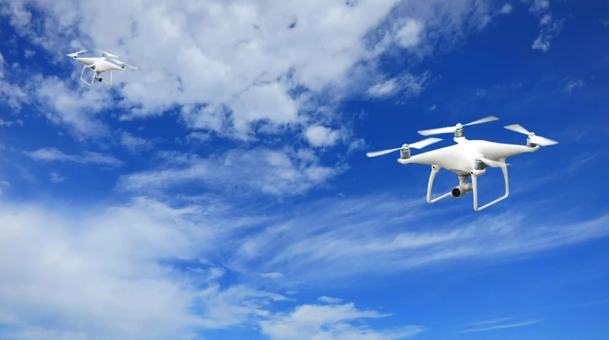 a couple of white drones flying through a blue sky, pixabay, hurufiyya, avatar image