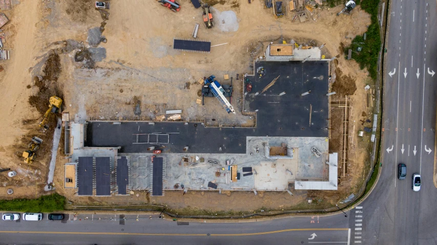 an aerial view of a building under construction, a portrait, by Carey Morris, unsplash, some of the blacktop is showing, 2 d overhead view, 3/4 front view, thumbnail