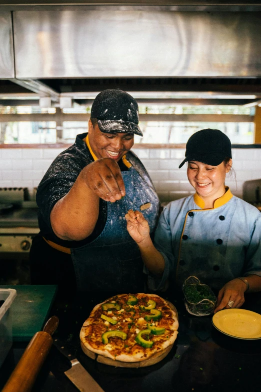 a couple of women standing next to each other in a kitchen, pexels contest winner, renaissance, cooking pizza, malaysian, workers, new zeeland