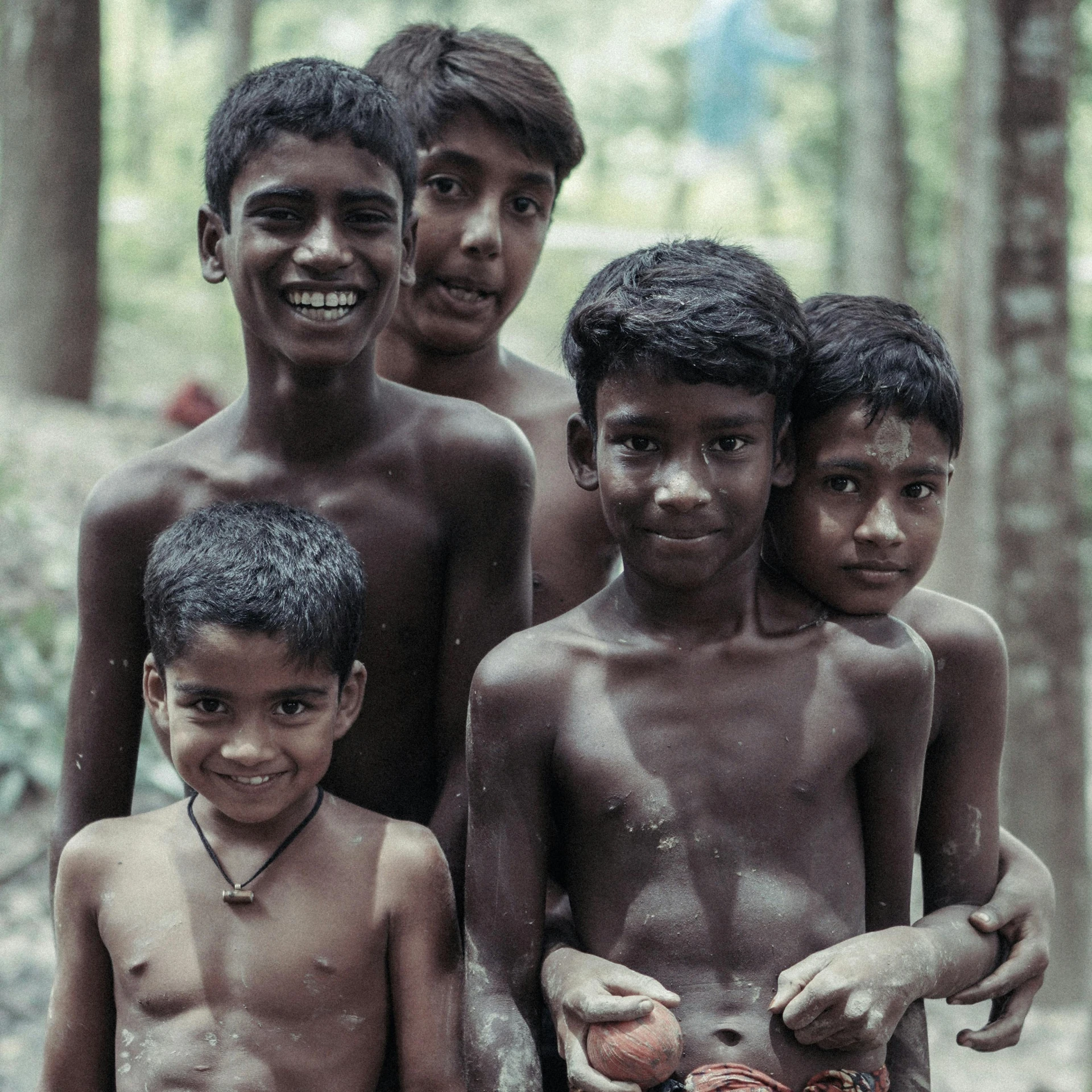 a group of young boys standing next to each other, pexels contest winner, sumatraism, indian girl with brown skin, of a shirtless, a still of a happy, indian forest