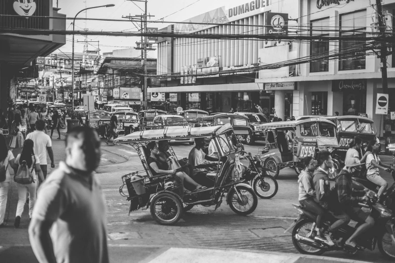 a black and white photo of a busy city street, a black and white photo, pexels contest winner, philippines, moped, square, brown