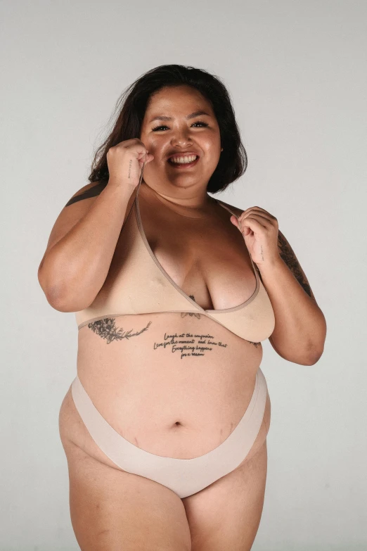 a woman in a bikini posing for a picture, a tattoo, inspired by Ruth Jên, an overweight, on clear background, promo photo, light tan