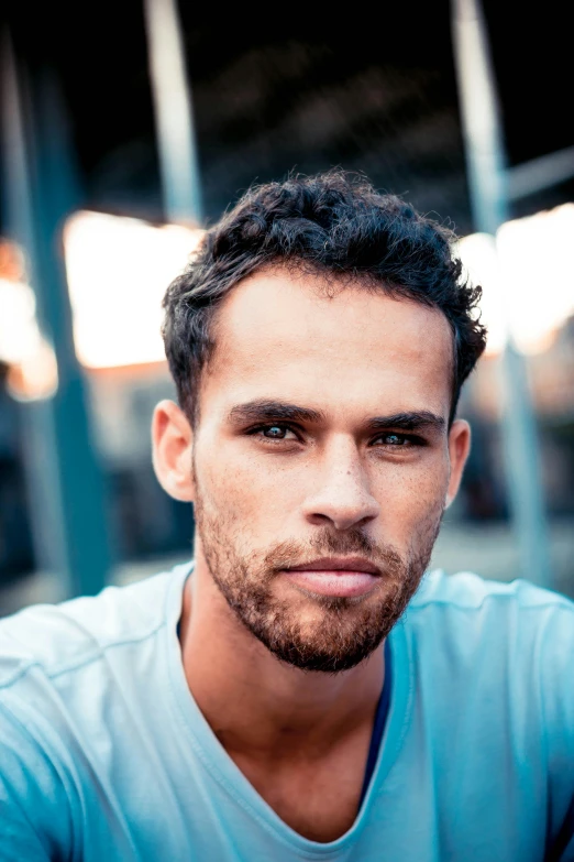 a man in a blue shirt posing for a picture, by Jacob Toorenvliet, happening, mixed race, wavy and short top hair, claudio bravo, square