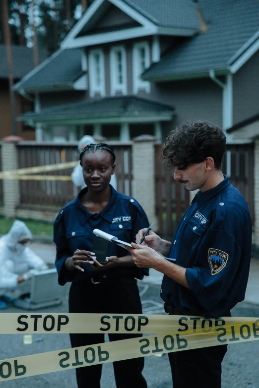 a couple of people that are standing in the street, by Andrew Stevovich, happening, crime scene, scene from live action movie, colored photo