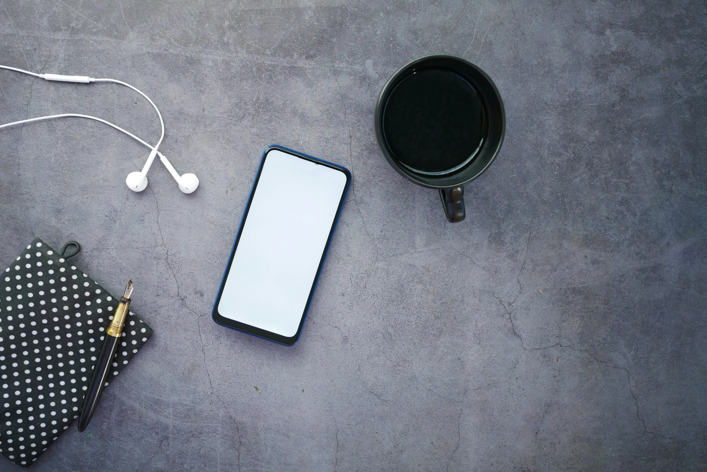 a cell phone sitting on top of a table next to a cup of coffee, trending on pexels, minimalism, wearing black headphones, panel of black, various posed, on a gray background