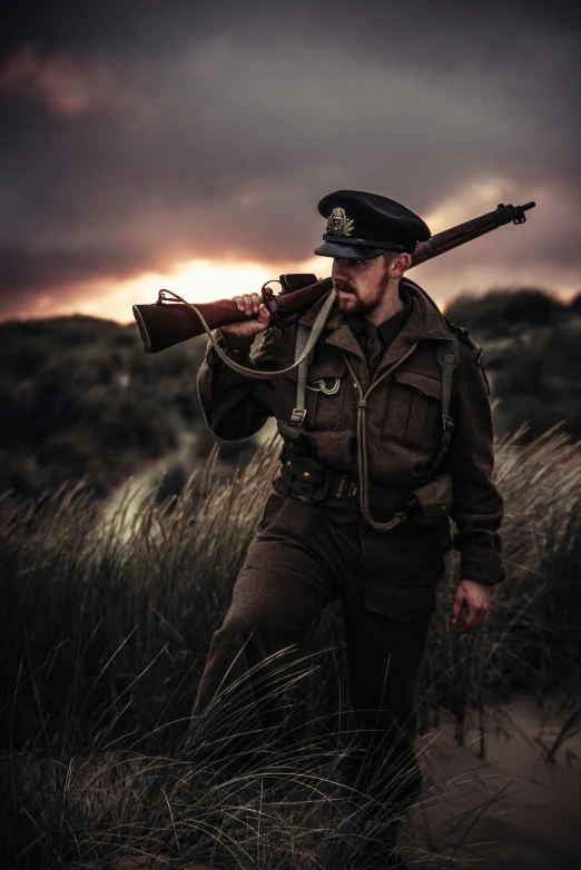 a man in a military uniform holding a rifle, by Gavin Nolan, unsplash, digital art, dunkirk, dunes, cinematic outfit photo, vintage photo