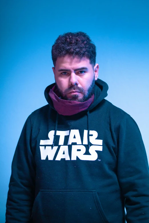 a man in a star wars hoodie poses for a picture, an album cover, inspired by George Lucas, featured on reddit, hurufiyya, portrait shot 8 k, trending on r/streetwear, hispanic, studio portrait photo