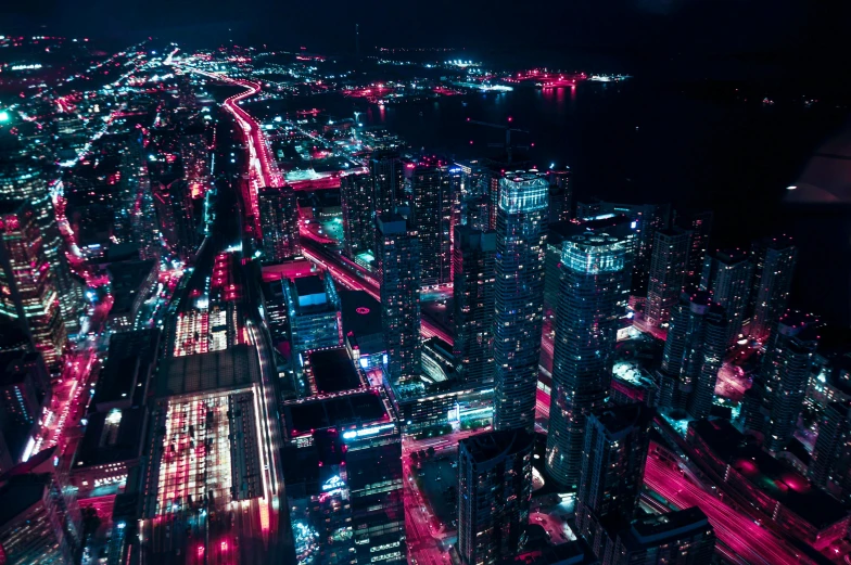 an aerial view of a city at night, cyberpunk art, by Beeple, unsplash contest winner, toronto, magenta and crimson and cyan, aerial photo night vision, instagram post