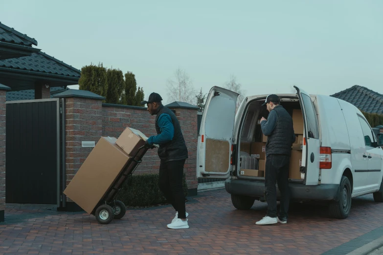 two men unloading boxes from a van, pexels contest winner, realism, low quality footage, avatar image, paul barson, riyahd cassiem