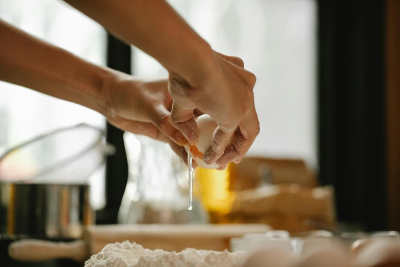 a close up of a person preparing food on a table, a marble sculpture, by Liza Donnelly, trending on pexels, cooking oil, manuka, bakery, natural hands and arms