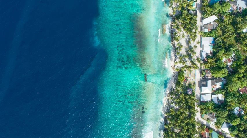 an aerial view of a small island in the middle of the ocean, pexels contest winner, maldives in background, thumbnail, bottom of ocean, subtle smile