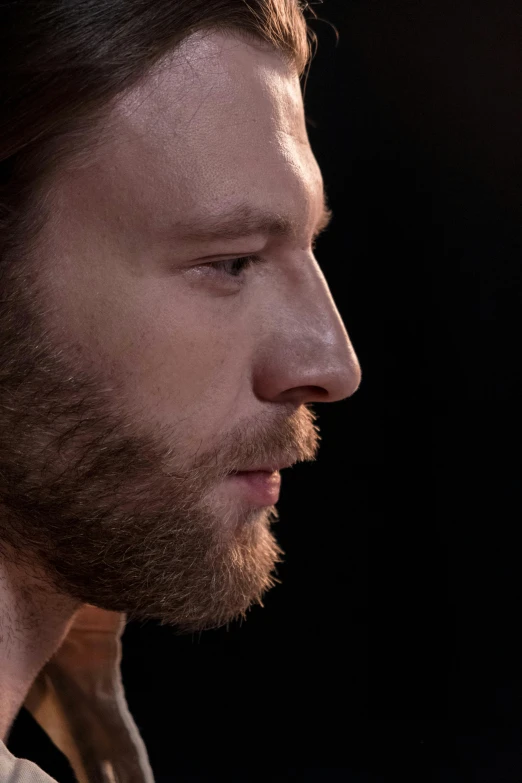 a close up of a person holding a cell phone, a character portrait, trending on reddit, photorealism, sharp jawline with a light beard, perfectly lit. movie still, aphex twin, dramatic lighting; 4k 8k