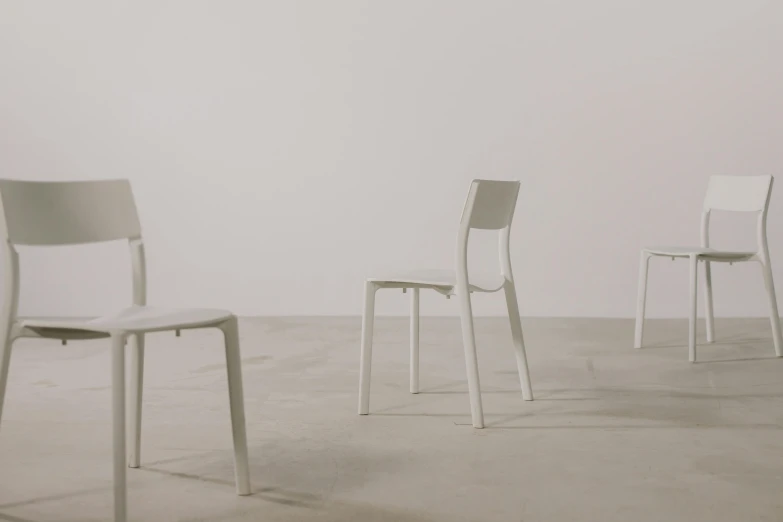 a couple of white chairs sitting next to each other, an ambient occlusion render, inspired by Adolfo Müller-Ury, unsplash, animation, philippe starck, very thin, malika favre