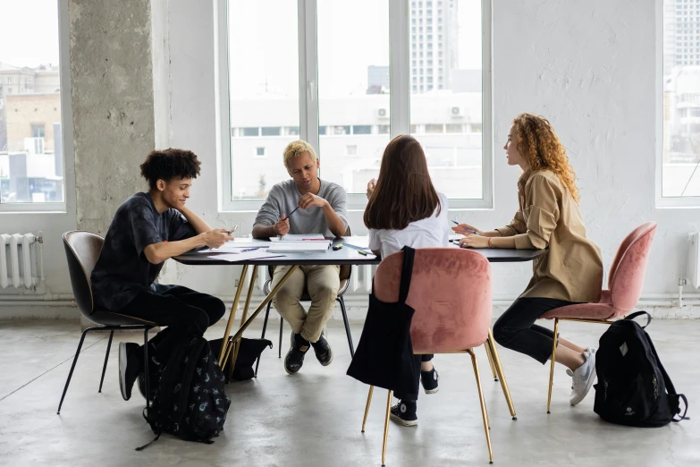 a group of people sitting around a table, white table