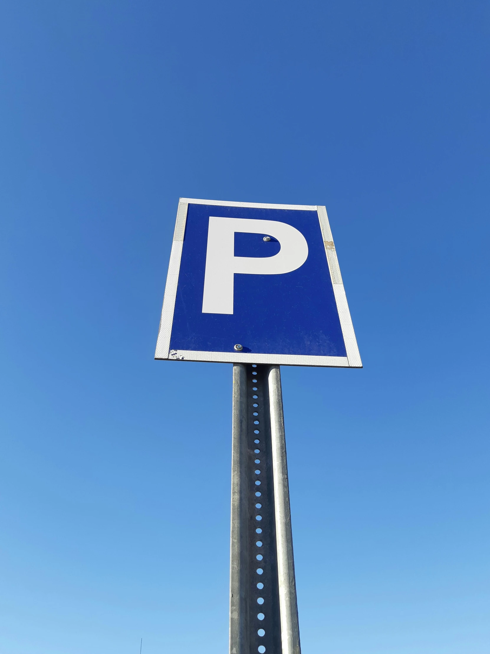 a blue and white parking sign sitting on top of a metal pole, a cartoon, unsplash, multiple stories, portlet photo