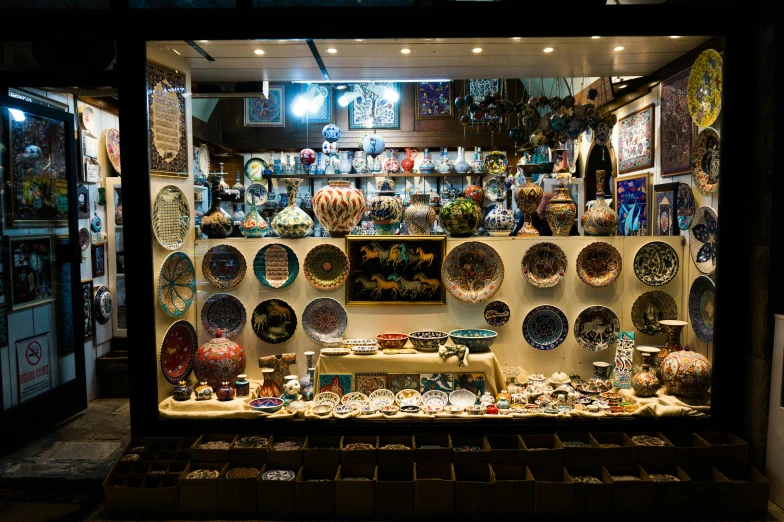 a store window filled with lots of decorative items, a mosaic, pexels contest winner, cloisonnism, night-time, turkey, panoramic shot, fan favorite