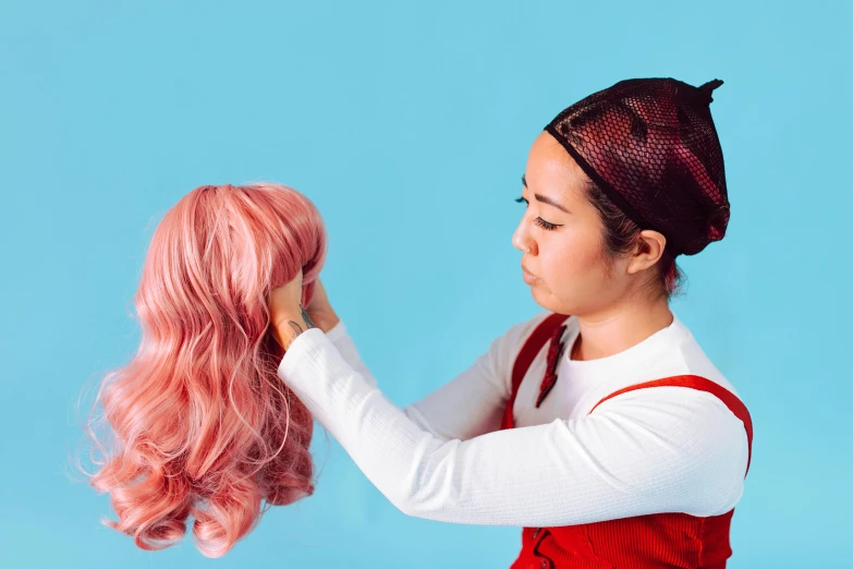 a woman in a red dress holding a pink wig, by Julia Pishtar, trending on pexels, cross section of mannequin head, vanellope von schweetz, transforming, gemma chen