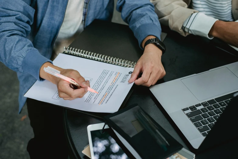 two people sitting at a table with laptops and papers, pexels contest winner, te pae, background image, selling insurance, no watermark