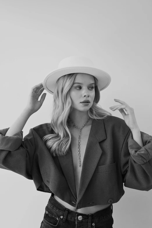 a black and white photo of a woman wearing a hat, trending on pexels, renaissance, sydney sweeney, white suit and hat, casual pose, erin moriarty