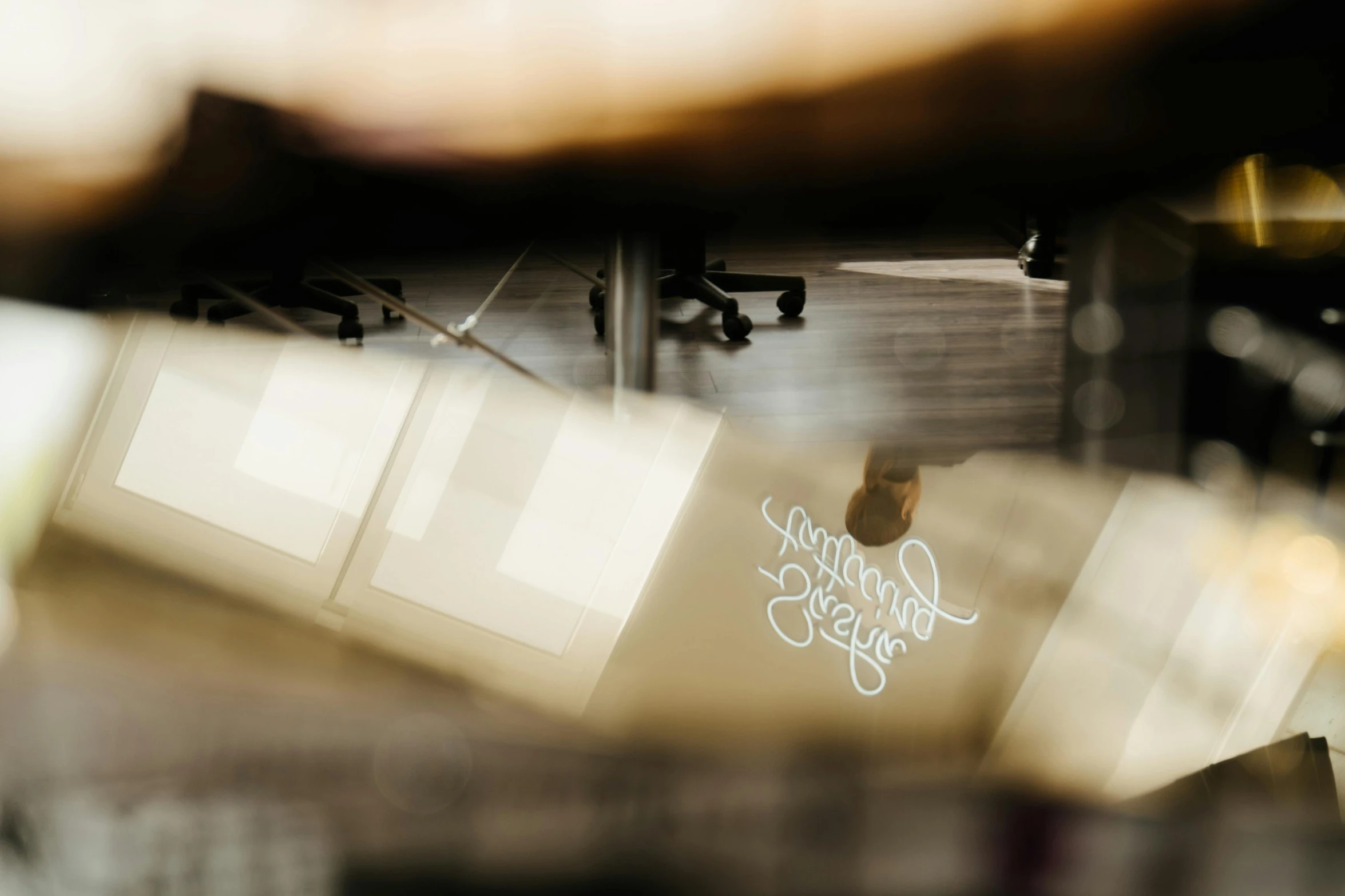 a man riding a skateboard on top of a skateboard ramp, an album cover, by Jessie Algie, trending on unsplash, light and space, sitting in office, estrange calligraphy, close-up shot taken from behind, reflected light