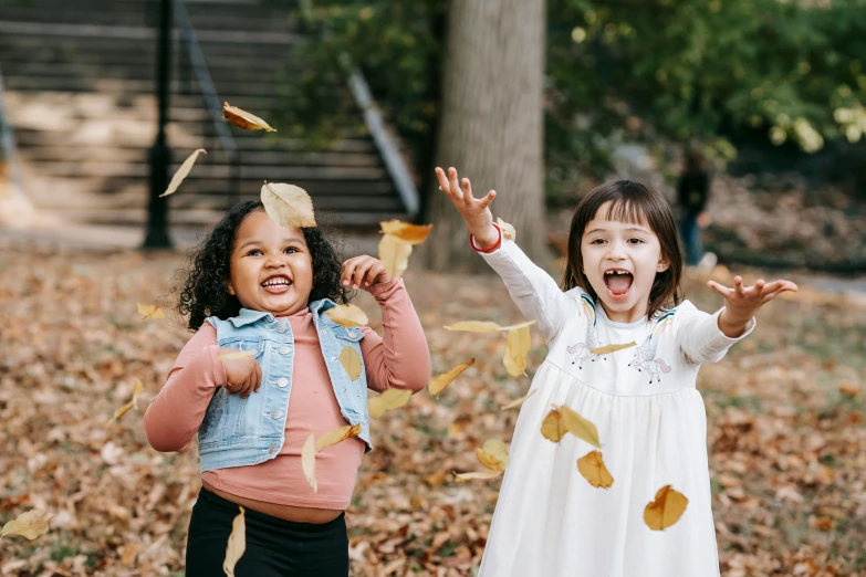 two little girls throwing leaves in the air, pexels contest winner, american barbizon school, avatar image, true realistic image, laughing out loud, cardboard