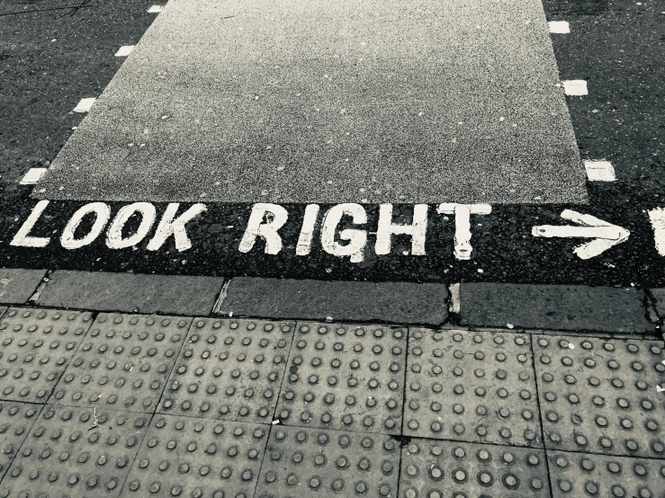 a black and white photo of a look right sign, by Romain brook, textbooks, (books), sidewalk, looks realistic
