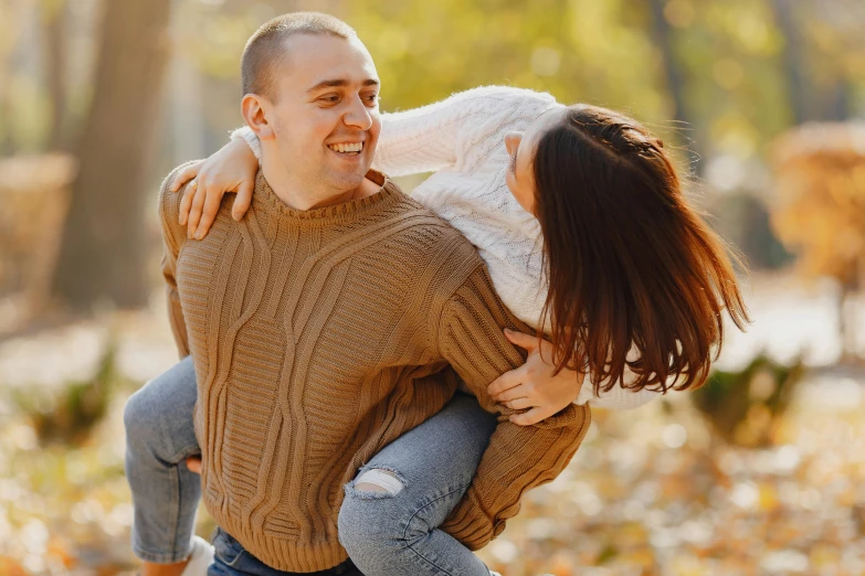 a man carrying a woman in his arms, pexels contest winner, he is wearing a brown sweater, avatar image, casual game, ukrainian