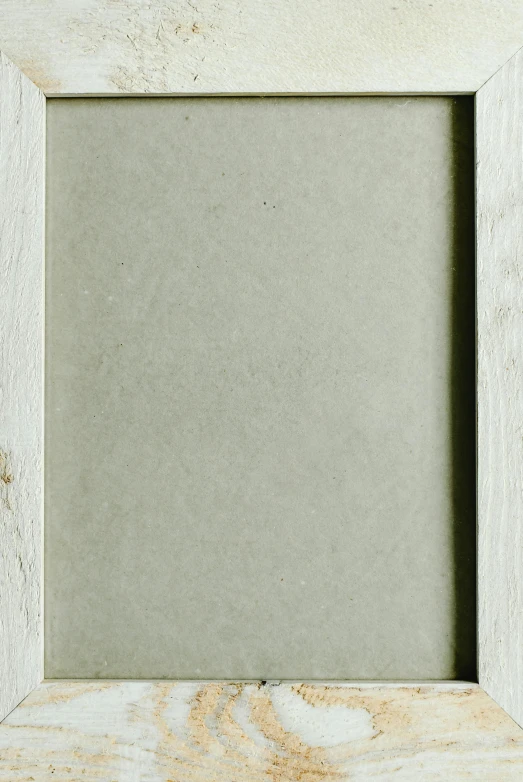 a picture frame sitting on top of a wooden table, a picture, white: 0.5, rectangular face, faded parchment, 2 0 0 0 s