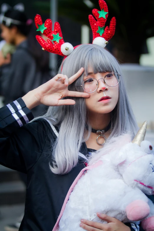 a close up of a person holding a stuffed animal, by Kanbun Master, wearing silver hair, young woman with antlers, street wear, square