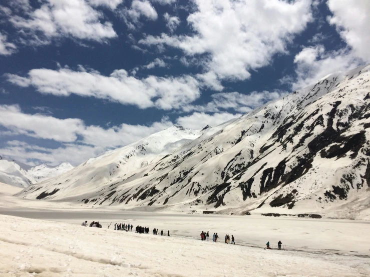 a group of people walking across a snow covered field, pexels contest winner, hurufiyya, beach is between the two valleys, himalayas, profile image, glacier coloring