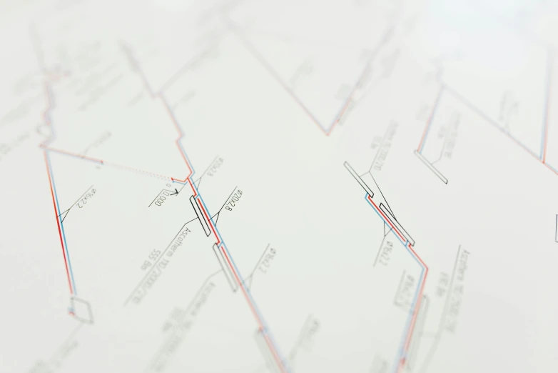 a close up of a piece of paper on a table, a poster, inspired by Cerith Wyn Evans, london underground tube station, detailed map, detailed product shot, thin red lines