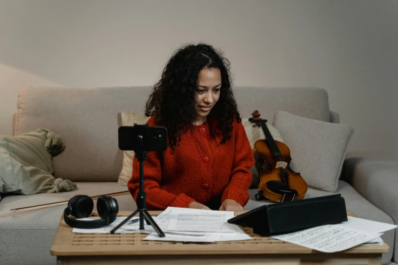 a woman sitting on a couch in front of a laptop computer, an album cover, pexels contest winner, orchestra, behind the scenes photo, avatar image, rosalia