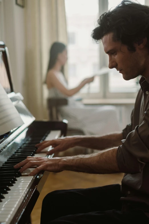 a man playing a piano in a living room, an album cover, by Anita Malfatti, pexels contest winner, romanticism, in a movie still cinematic, australian, eng kilian, sheet music