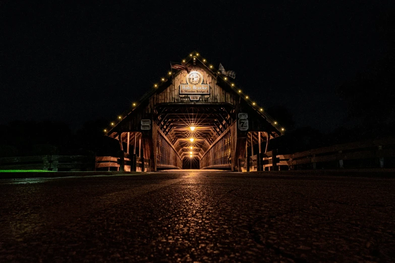 a wooden covered bridge lit up at night, a portrait, inspired by Terry Redlin, unsplash contest winner, symmetrical image, thumbnail, holiday season, nostalgic 8k