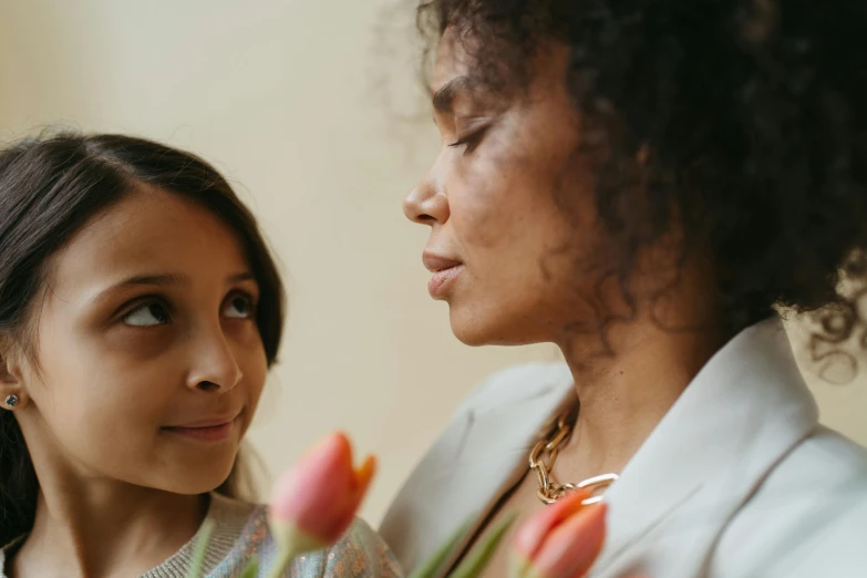 a woman standing next to a woman holding a bouquet of flowers, pexels contest winner, renaissance, tiny girl looking on, mixed race, thoughtful ), motherly