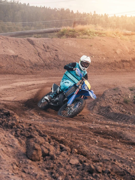 a person riding a dirt bike on a dirt track, profile image